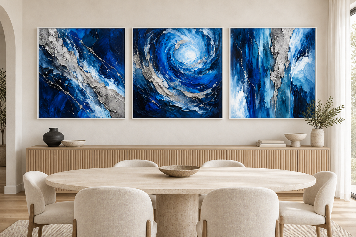 The Trident abstract blue and silver canvas set in white frames above an oak dining-room sideboard.